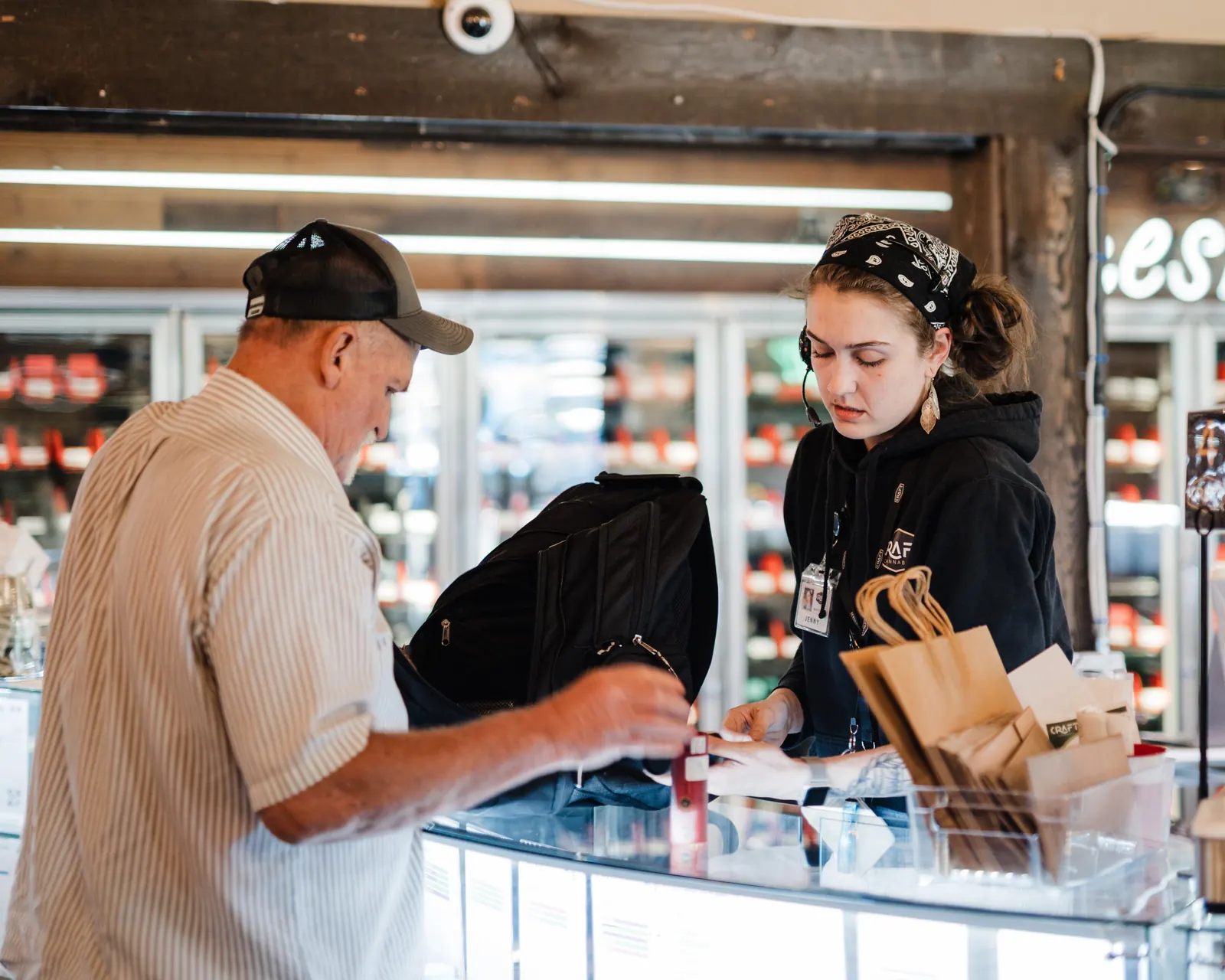 A budtender helping a customer at the Craft Cannabis counter